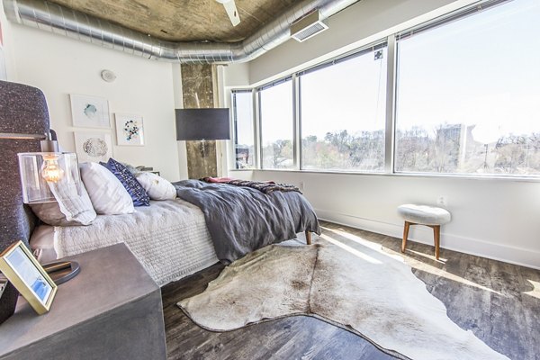 Cozy bedroom with modern furnishings at Elofts Apartments, Greystar luxury apartments in the city center