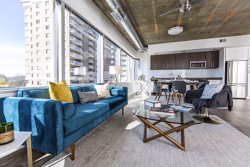 Modern living room with chic decor and abundant natural light at Elofts Apartments