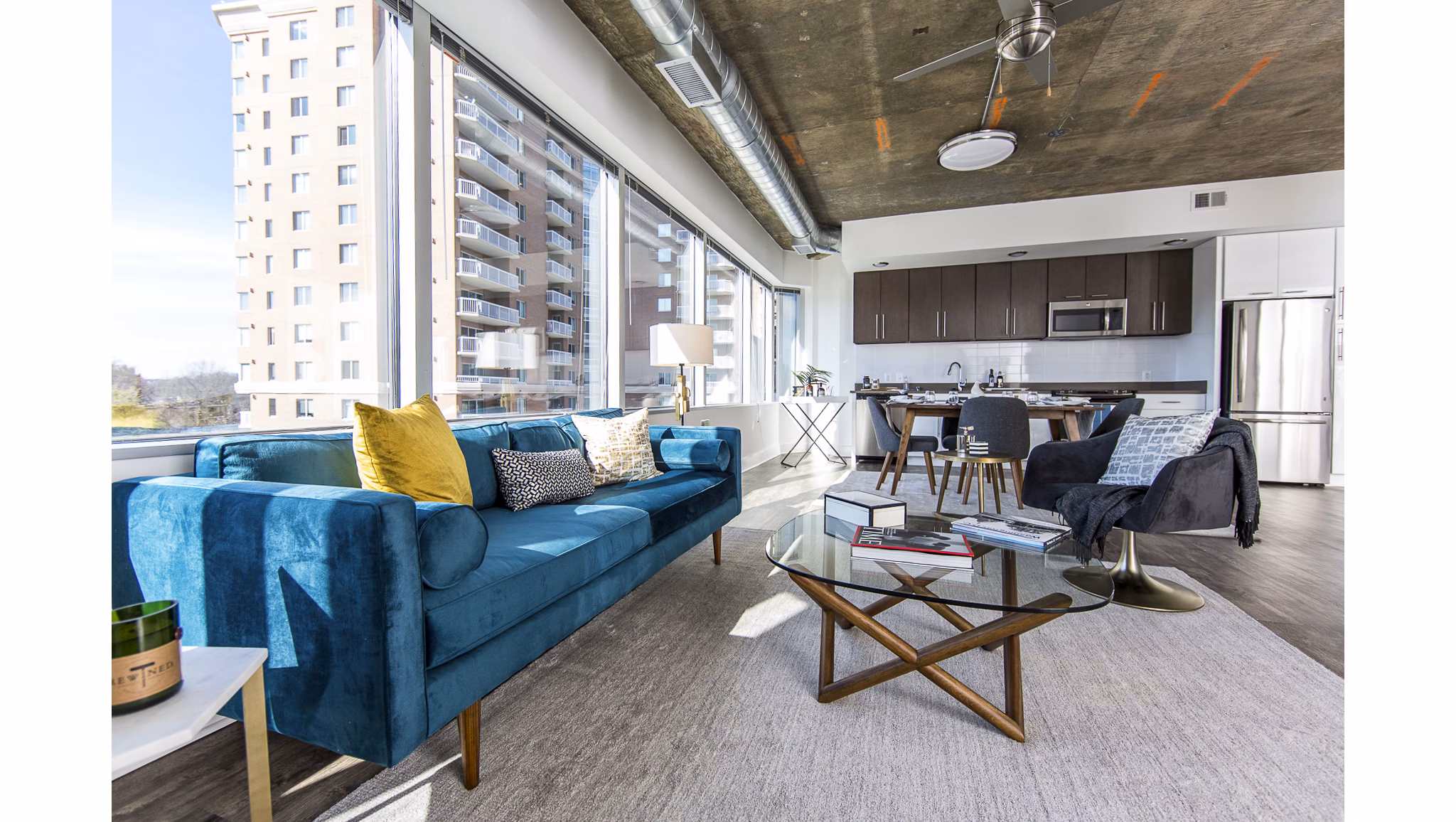 Modern living room with chic decor and abundant natural light at Elofts Apartments