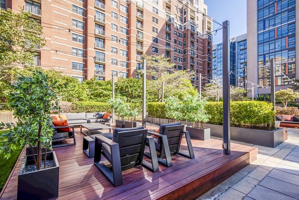 Cozy outdoor patio area at Elofts Apartments featuring comfortable seating and lush greenery, perfect for relaxation and gatherings