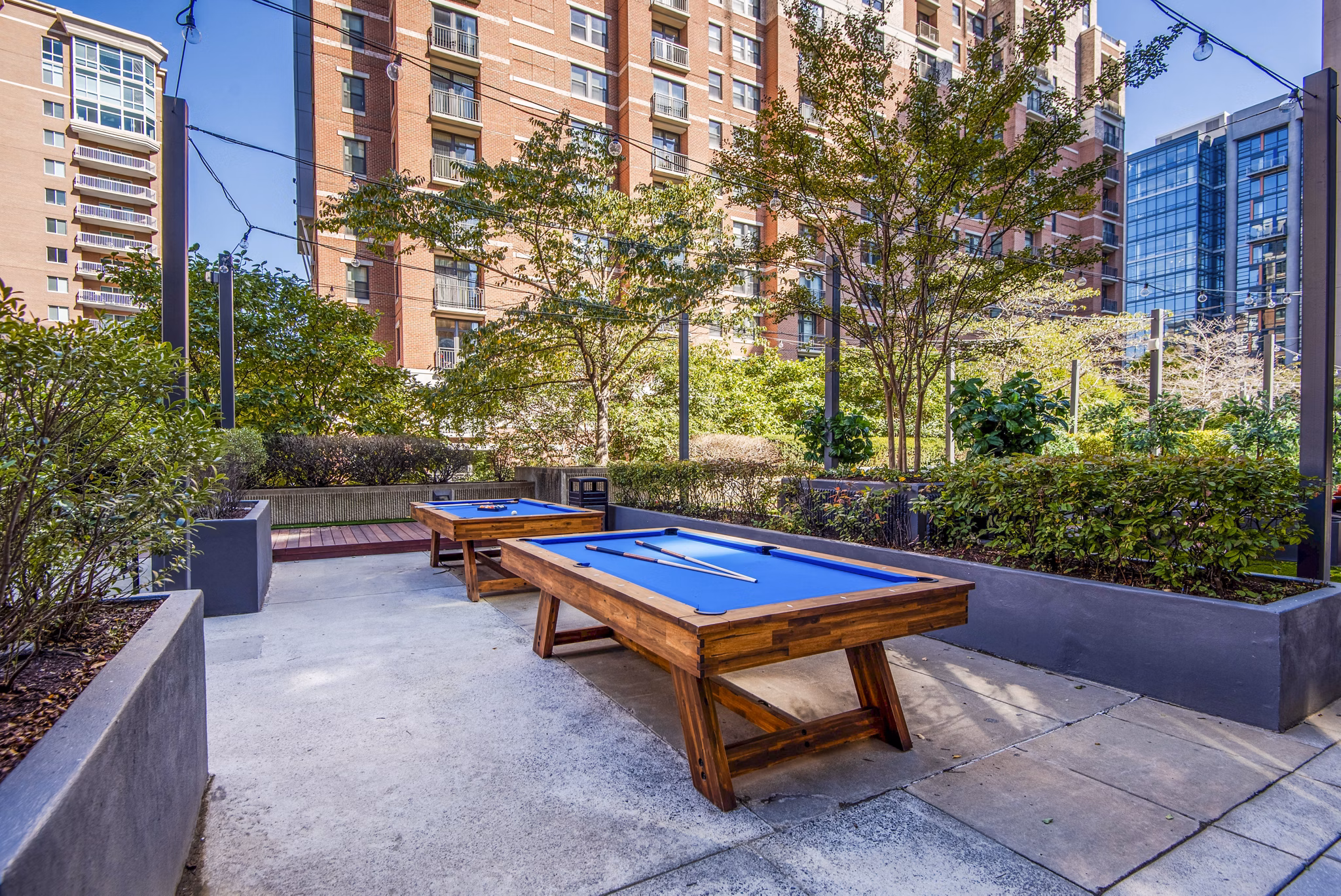 Relaxing patio and recreational area at Elofts Apartments offering outdoor seating and lush greenery for a serene living experience