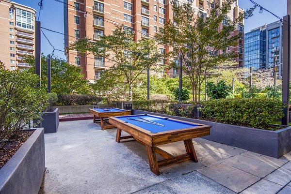 Relaxing patio and recreational area at Elofts Apartments offering outdoor seating and lush greenery for a serene living experience