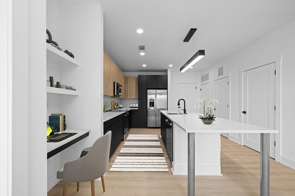 Modern kitchen with granite countertops and stainless steel appliances at Elan LoSo Apartments