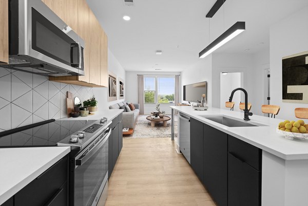 Modern kitchen with sleek appliances at Elan LoSo Apartments