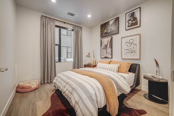 Cozy bedroom with stylish decor at CINQ Apartments featuring modern luxury and comfort