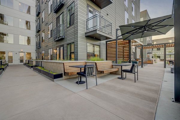 Spacious patio with modern seating at CINQ Apartments, perfect for relaxing in a luxurious setting