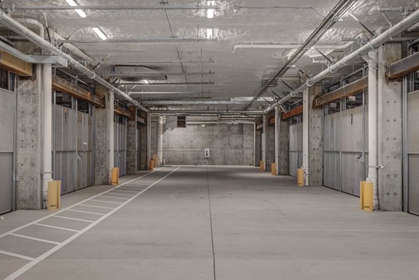 Covered parking garage at The DeWitt Apartments featuring secure access and ample space for residents' vehicles