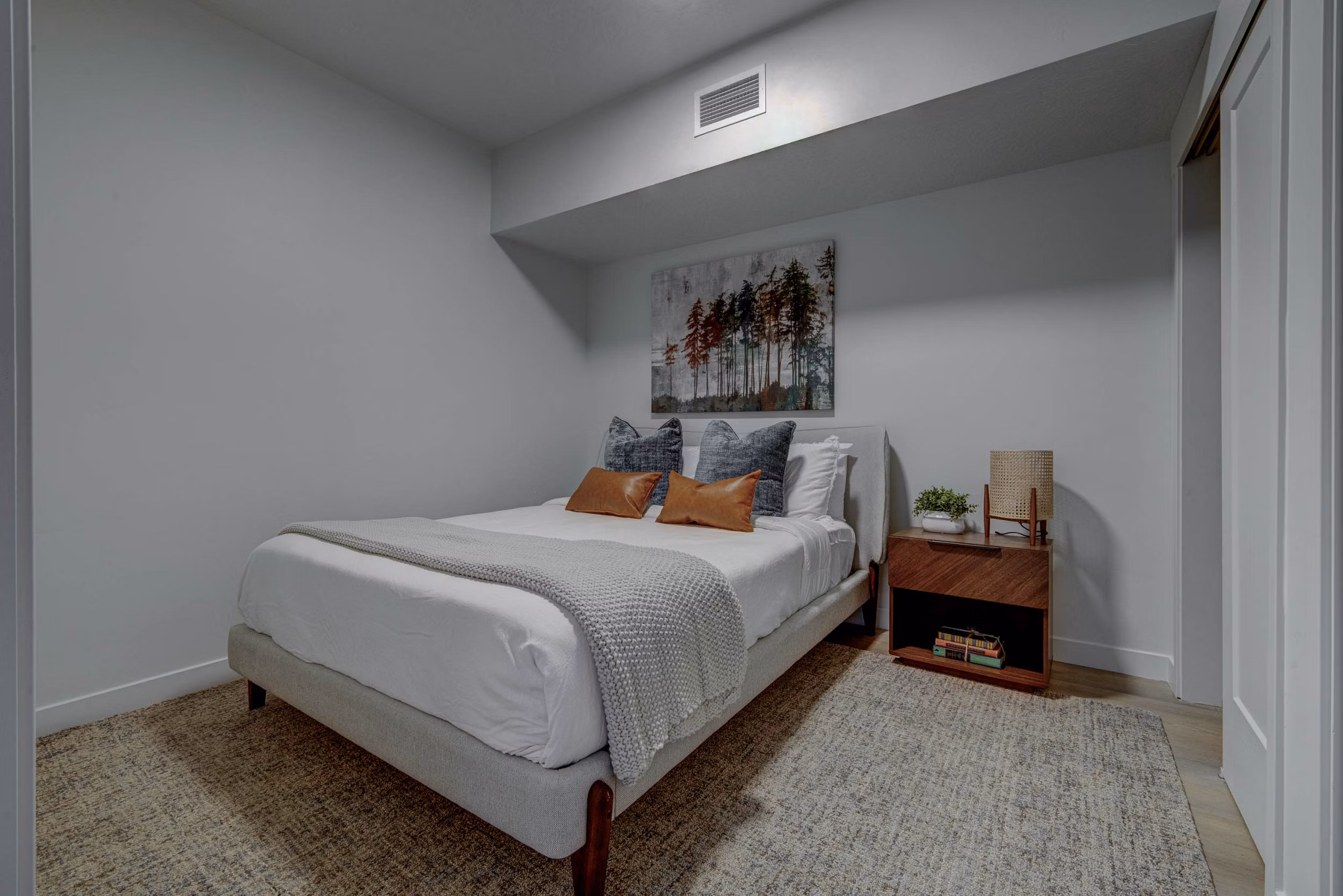 Cozy bedroom with modern decor and natural light at The DeWitt Apartments