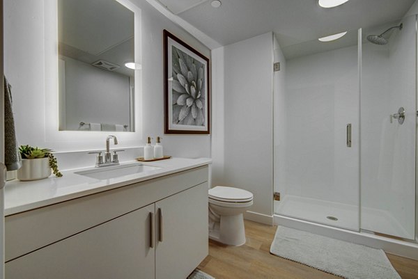 Modern bathroom with sleek fixtures at The DeWitt Apartments, luxury living by Greystar in a vibrant city setting