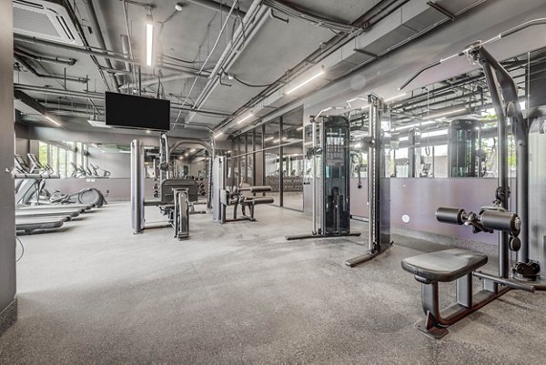 State-of-the-art fitness center at The DeWitt Apartments featuring modern equipment and bright open spaces