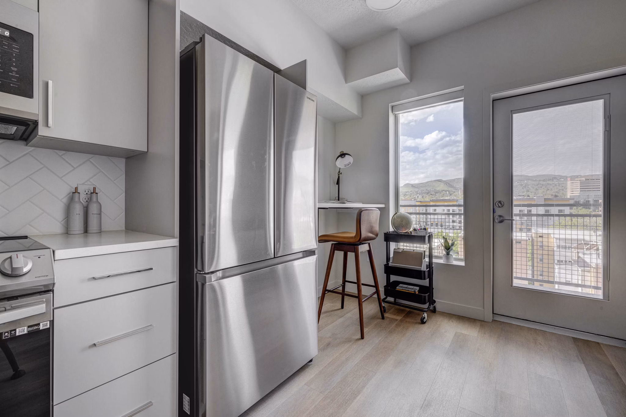 Modern kitchen with stainless steel appliances at The DeWitt Apartments