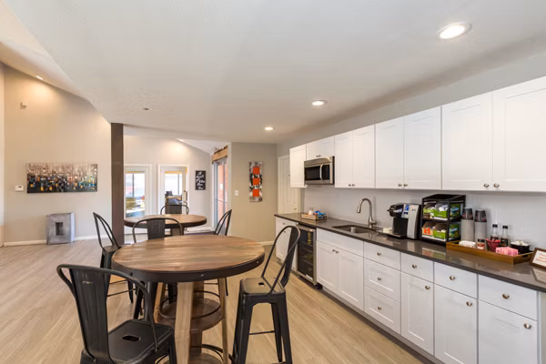 Modern clubhouse with cozy seating and pool table at Retreat at Fitzsimons Apartments, perfect for relaxation and entertainment