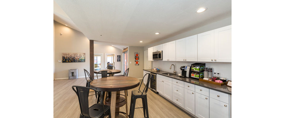 Modern clubhouse with cozy seating and pool table at Retreat at Fitzsimons Apartments, perfect for relaxation and entertainment