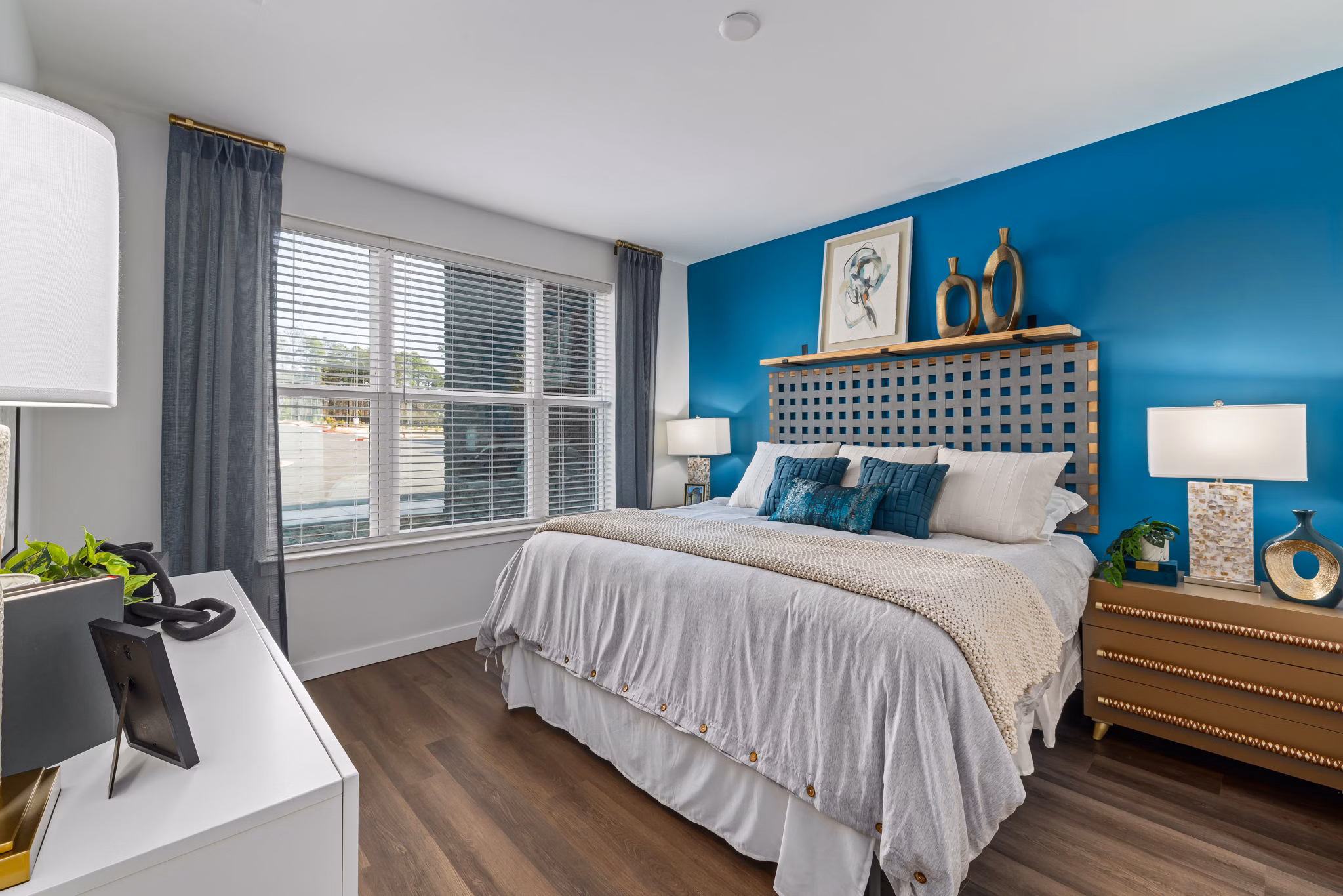 Elegant master bedroom with modern decor at The Slater Apartments