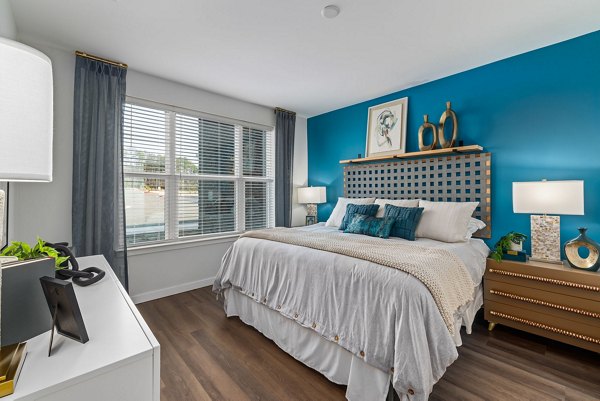Elegant master bedroom with modern decor at The Slater Apartments
