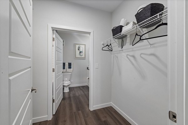 Walk-in closet with built-in shelves at The Slater Apartments, offering ample storage in modern luxury apartments
