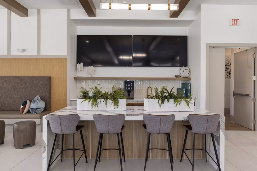 The Slater Apartments: Contemporary clubhouse with inviting seating areas and modern design in vibrant community