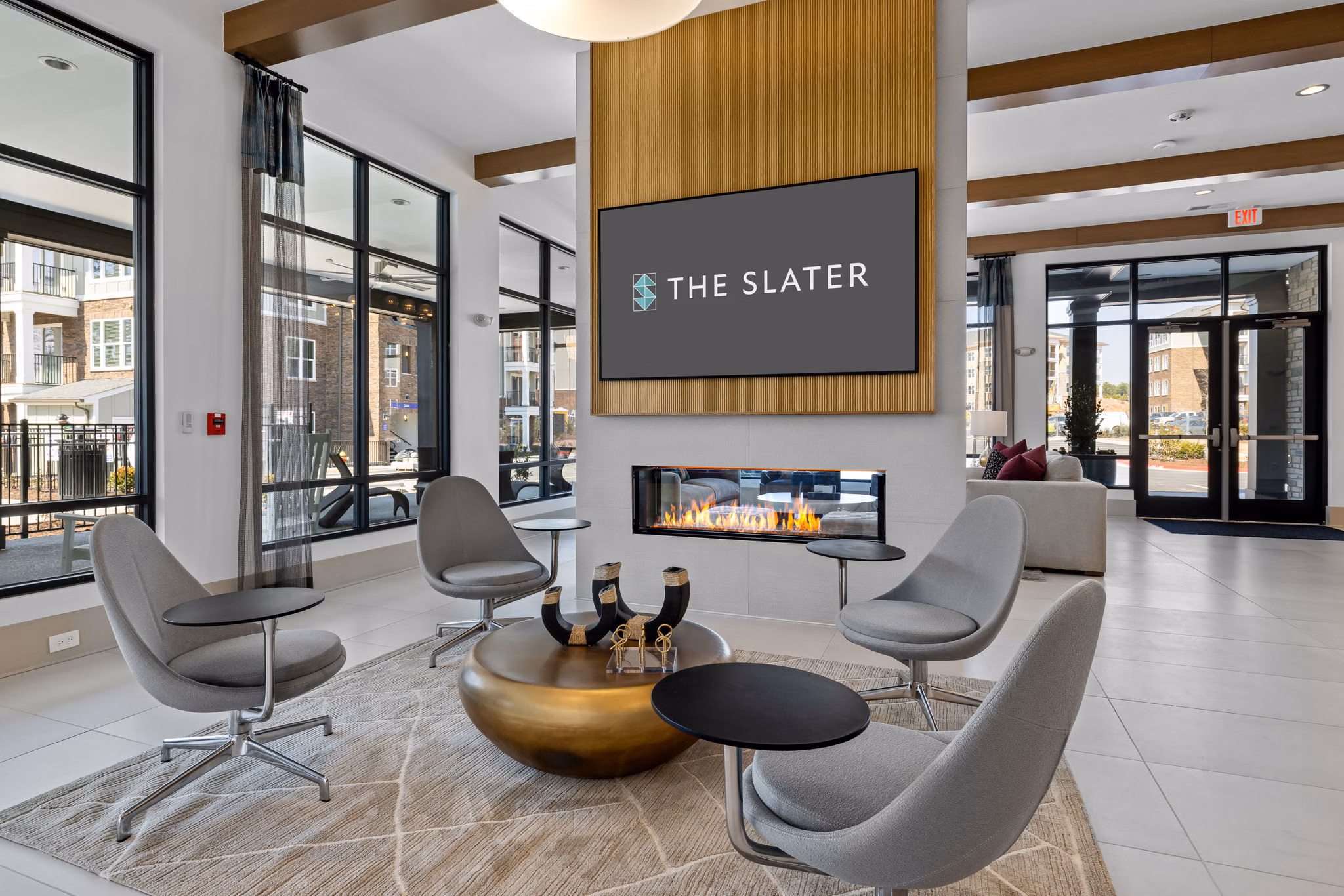The Slater Apartments: Contemporary clubhouse with inviting seating areas and modern design in vibrant community