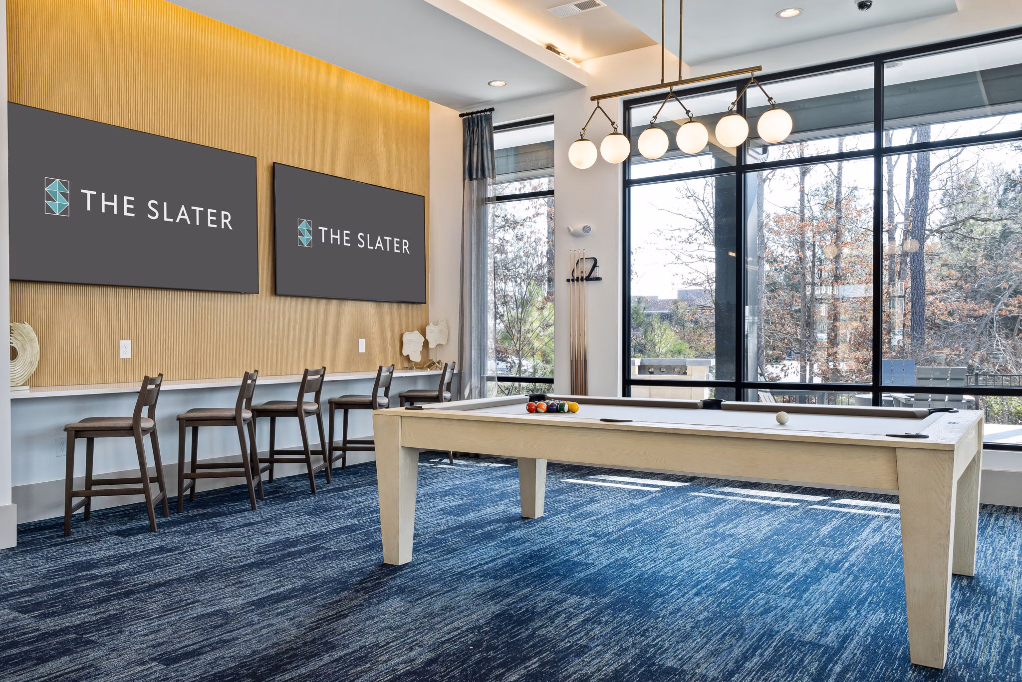 Game room with pool table and modern decor at The Slater Apartments, a luxury residential community