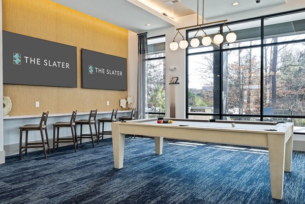 Game room with pool table and modern decor at The Slater Apartments, a luxury residential community