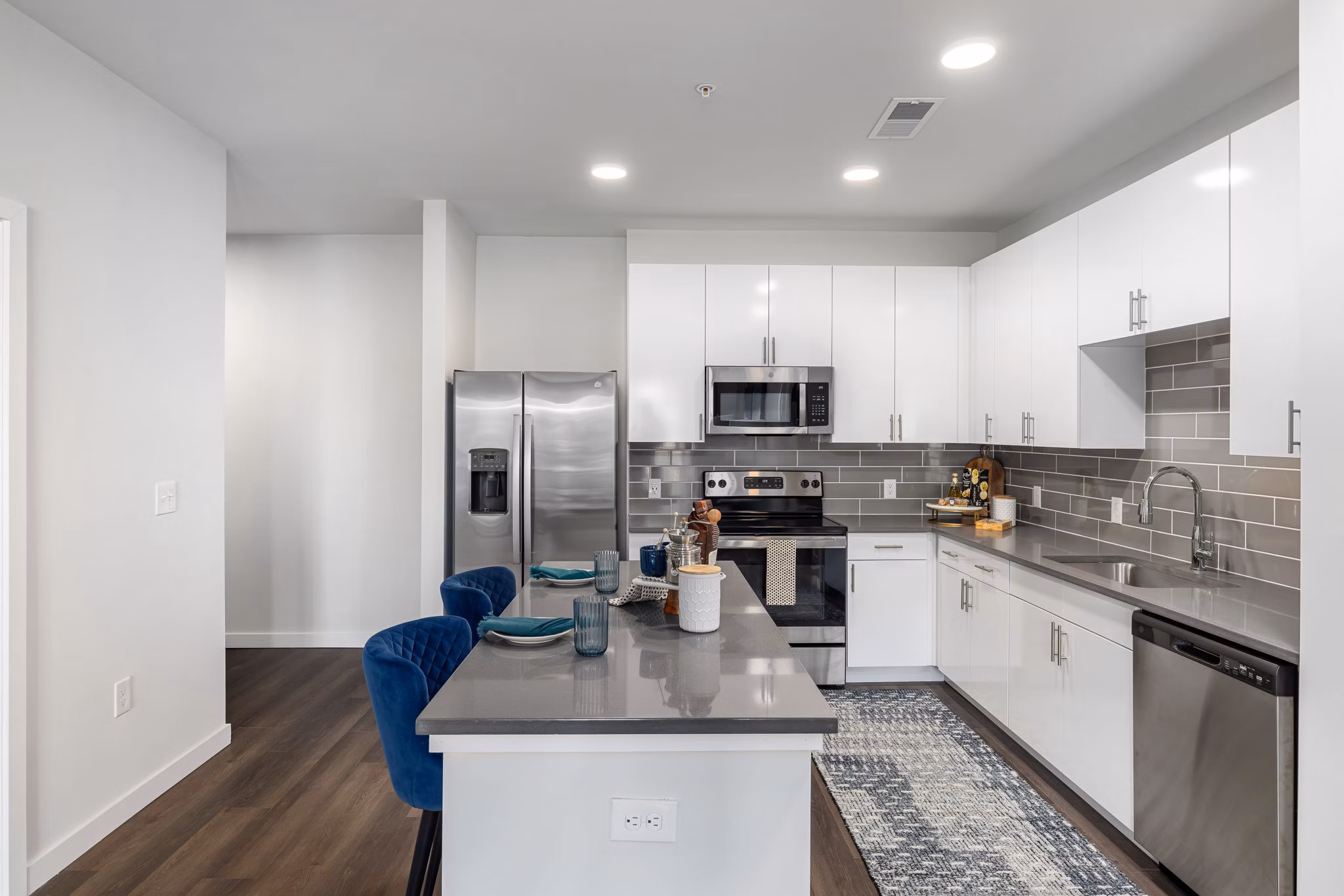 Modern kitchen with stainless steel appliances at The Slater Apartments, offering luxury urban living