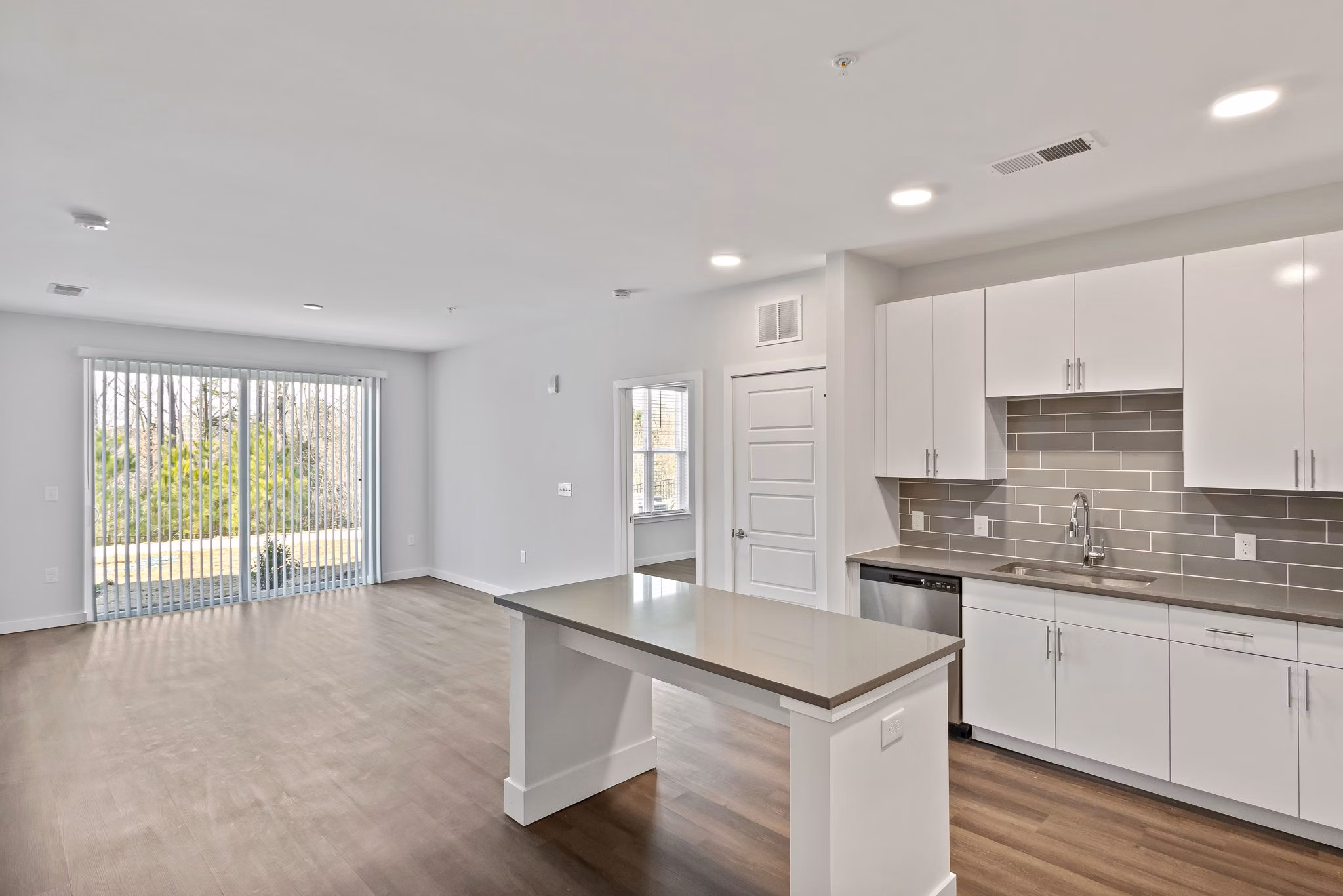 Modern kitchen with stainless steel appliances at The Slater Apartments, luxury property by Greystar