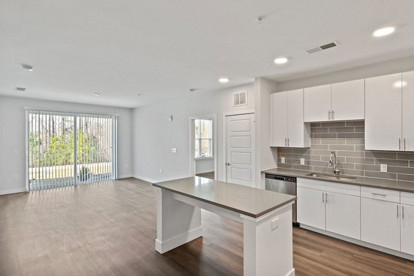 Modern kitchen with stainless steel appliances at The Slater Apartments, luxury property by Greystar