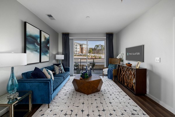 Spacious living room with stylish decor at The Slater Apartments, featuring luxury living options in urban settings
