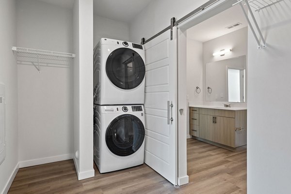 Laundry room equipped with modern appliances at The Slater Apartments