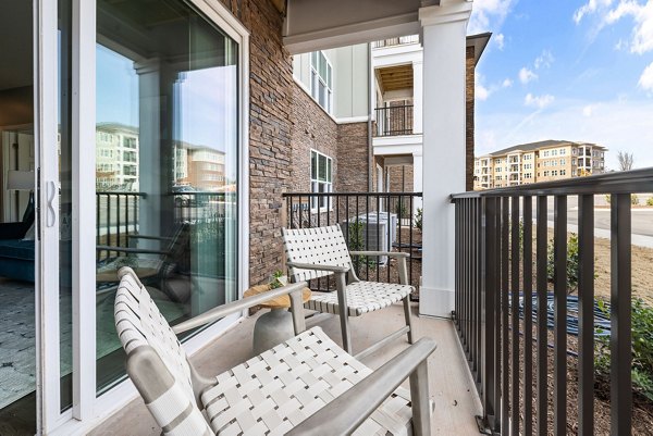 Patio area with modern outdoor furniture at The Slater Apartments, offering a relaxing environment for residents