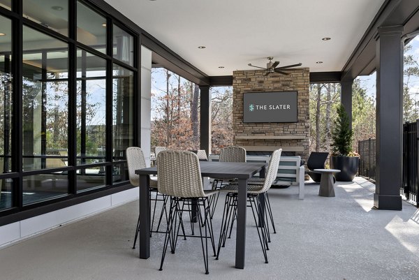 The Slater Apartments: Cozy outdoor patio with seating and greenery