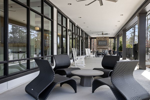 Cozy outdoor patio with modern furniture at The Slater Apartments, ideal for relaxation and social gatherings