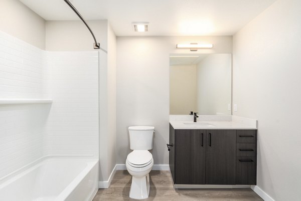 Luxurious bathroom featuring a modern vanity and glass shower in Sofia Apartments