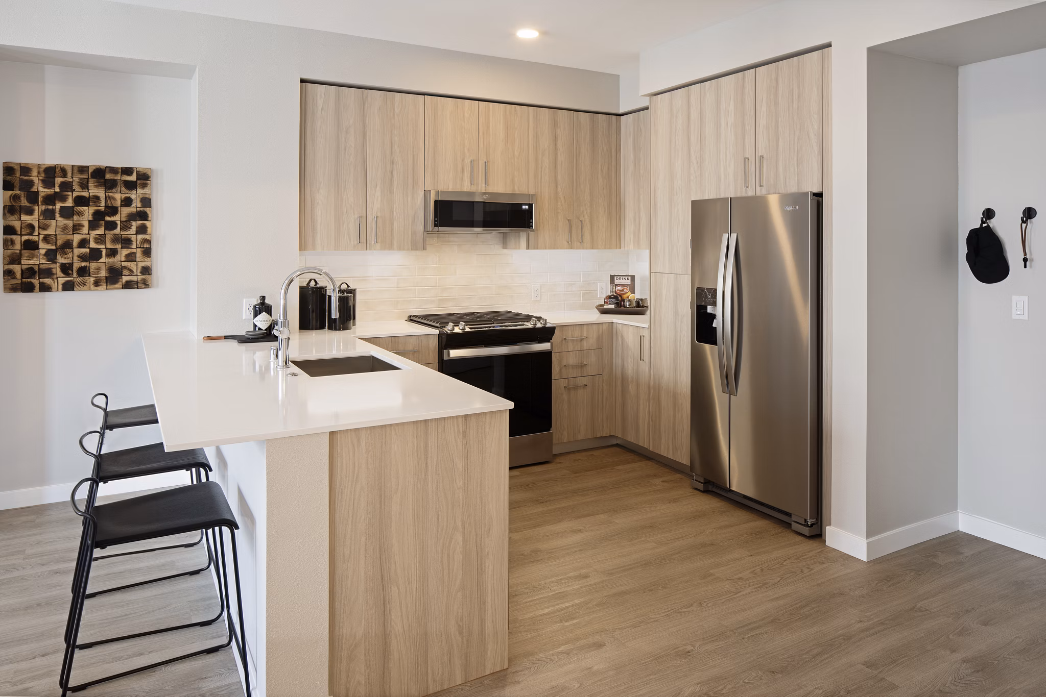 Modern kitchen with stainless steel appliances and breakfast bar in Sofia Apartments