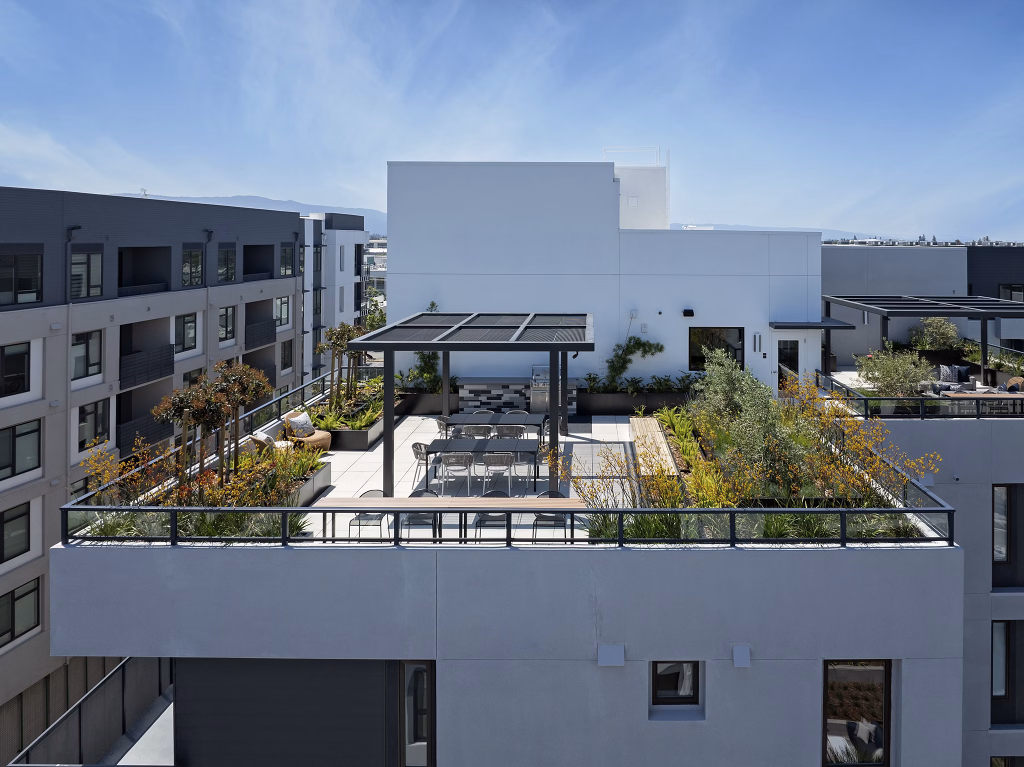 Rooftop relaxation area with seating and city skyline views at Sofia Apartments