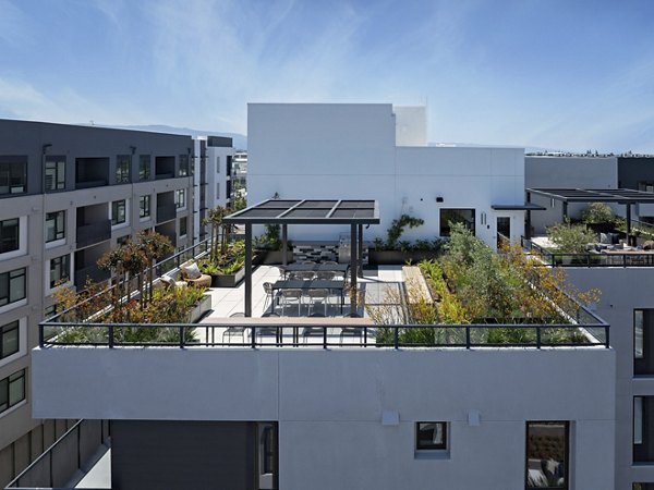 Rooftop relaxation area with seating and city skyline views at Sofia Apartments