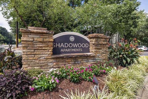 Shadowood Apartments: Elegant signage at luxury complex in vibrant setting