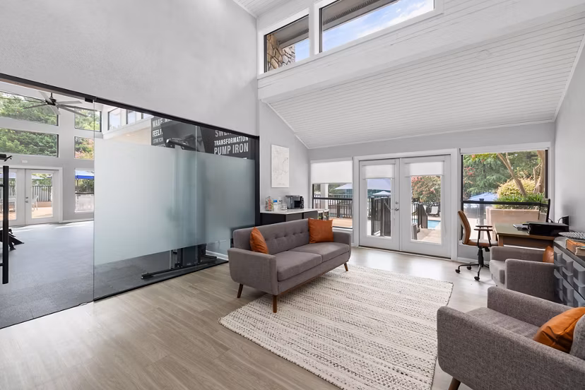 Clubhouse with modern decor and lounge seating at Sunstone Apartments, offering luxury living amenities