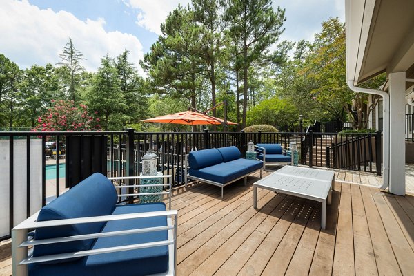 Modern community clubhouse with spacious seating and large screen TV at Sunstone Apartments, ideal for social gatherings and relaxation