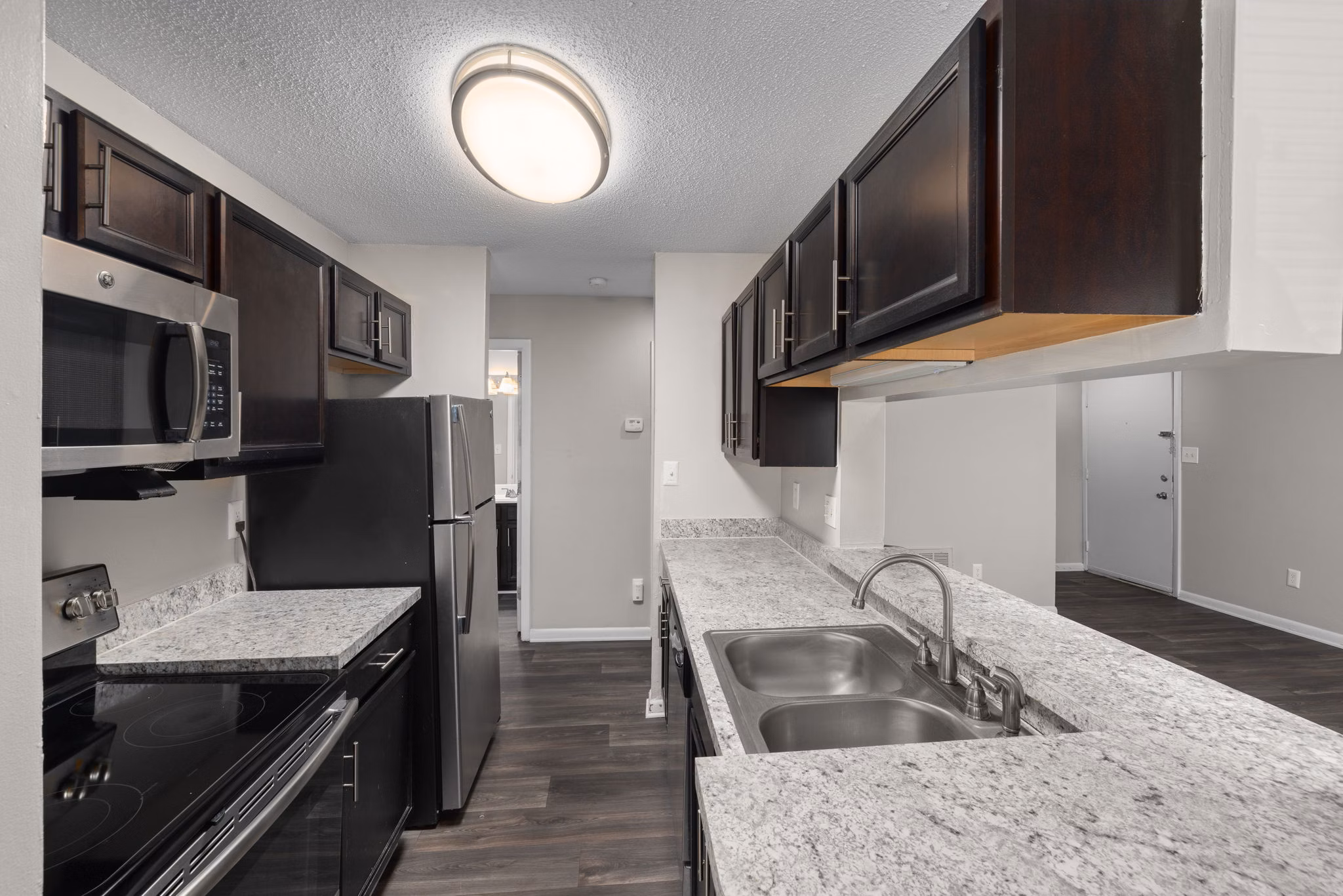 Modern kitchen with stainless steel appliances at Sunstone Apartments, luxury living by Greystar