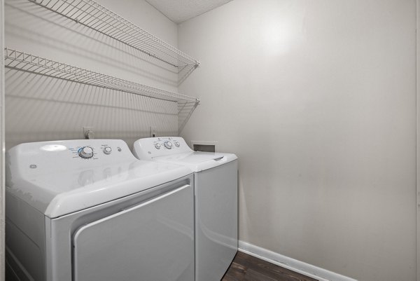 Sunstone Apartments: Modern laundry room with energy-efficient machines and ample folding space
