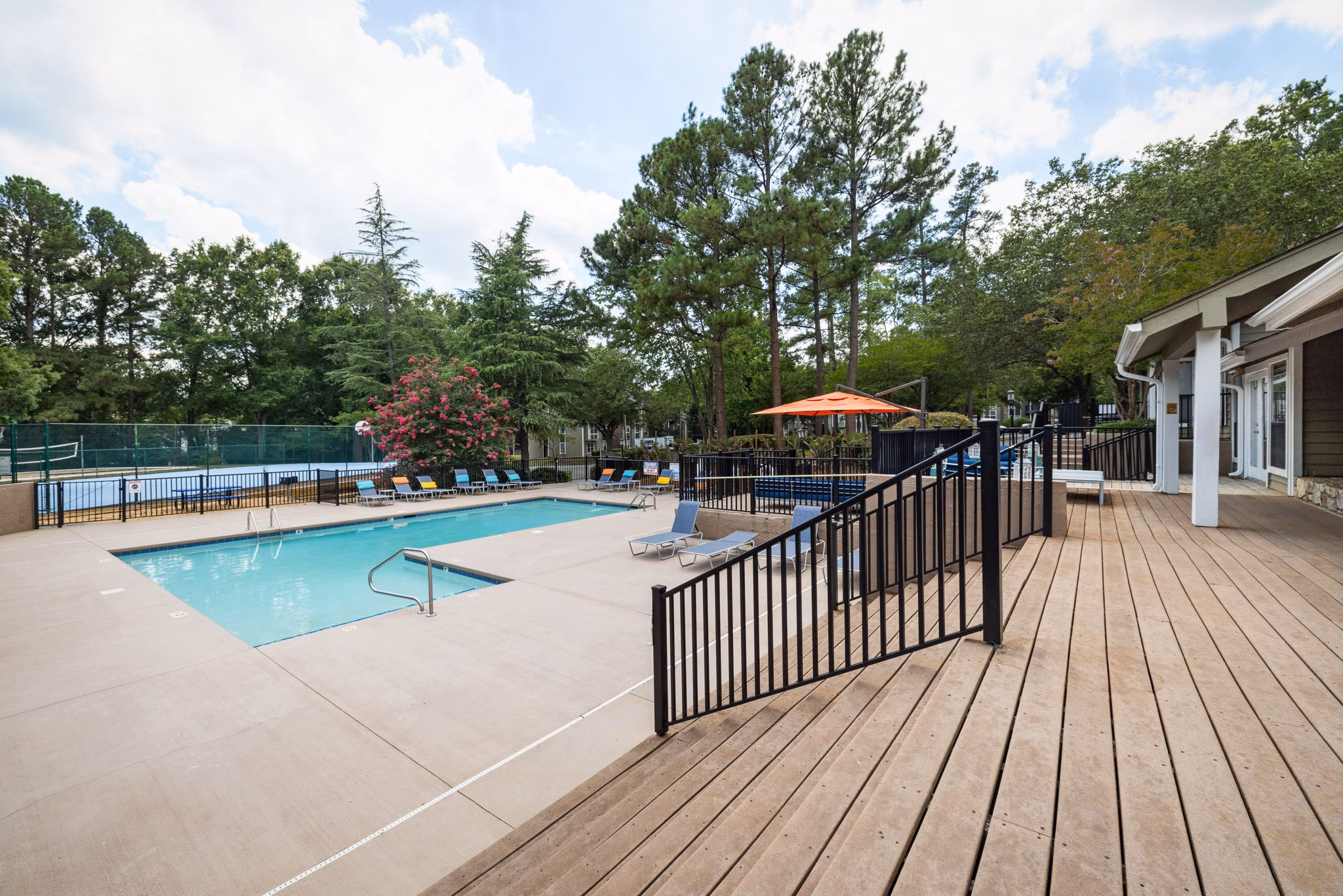 Sunstone Apartments: Modern pool area with stylish loungers and lush landscaping for residents to enjoy and relax