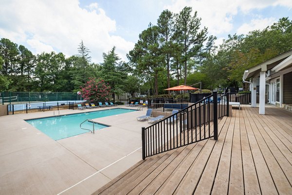 Sunstone Apartments: Modern pool area with stylish loungers and lush landscaping for residents to enjoy and relax