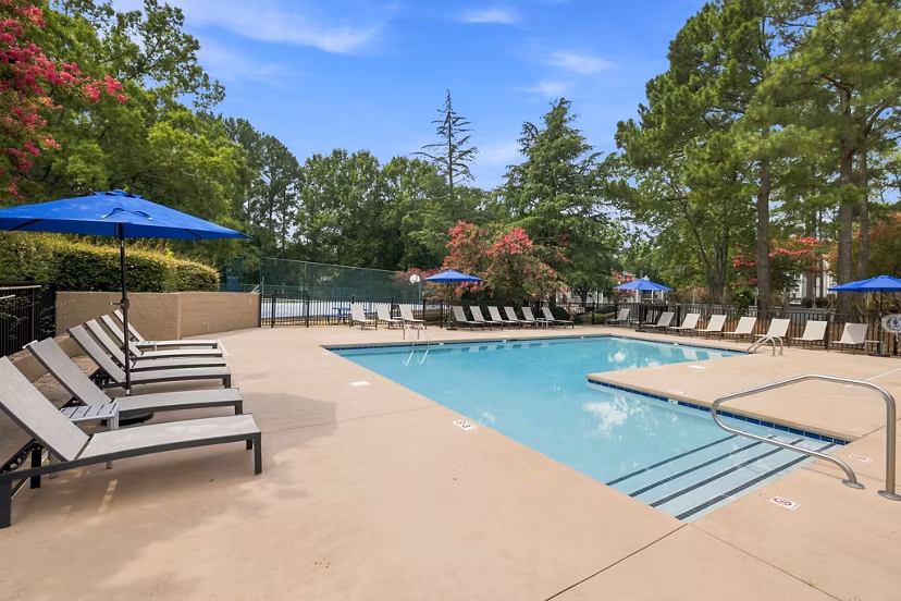 Resort-style pool with lounge chairs at Sunstone Apartments offering luxury living experiences