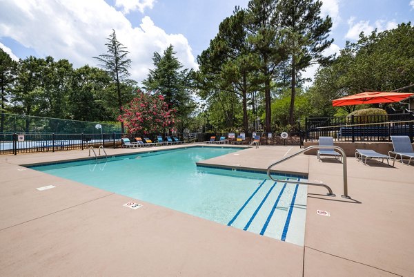 Resort-style pool with lounge chairs at Sunstone Apartments offering luxury living experiences