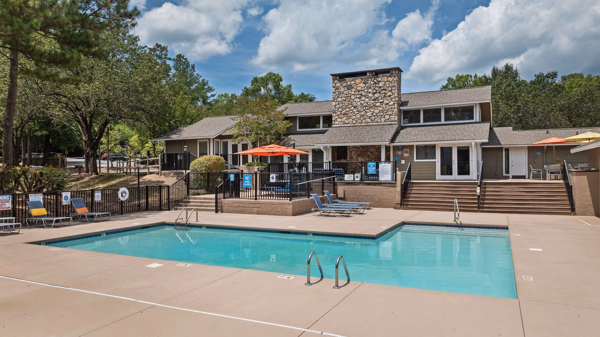 Sunstone Apartments: Modern outdoor pool with surrounding lounge area in luxury complex