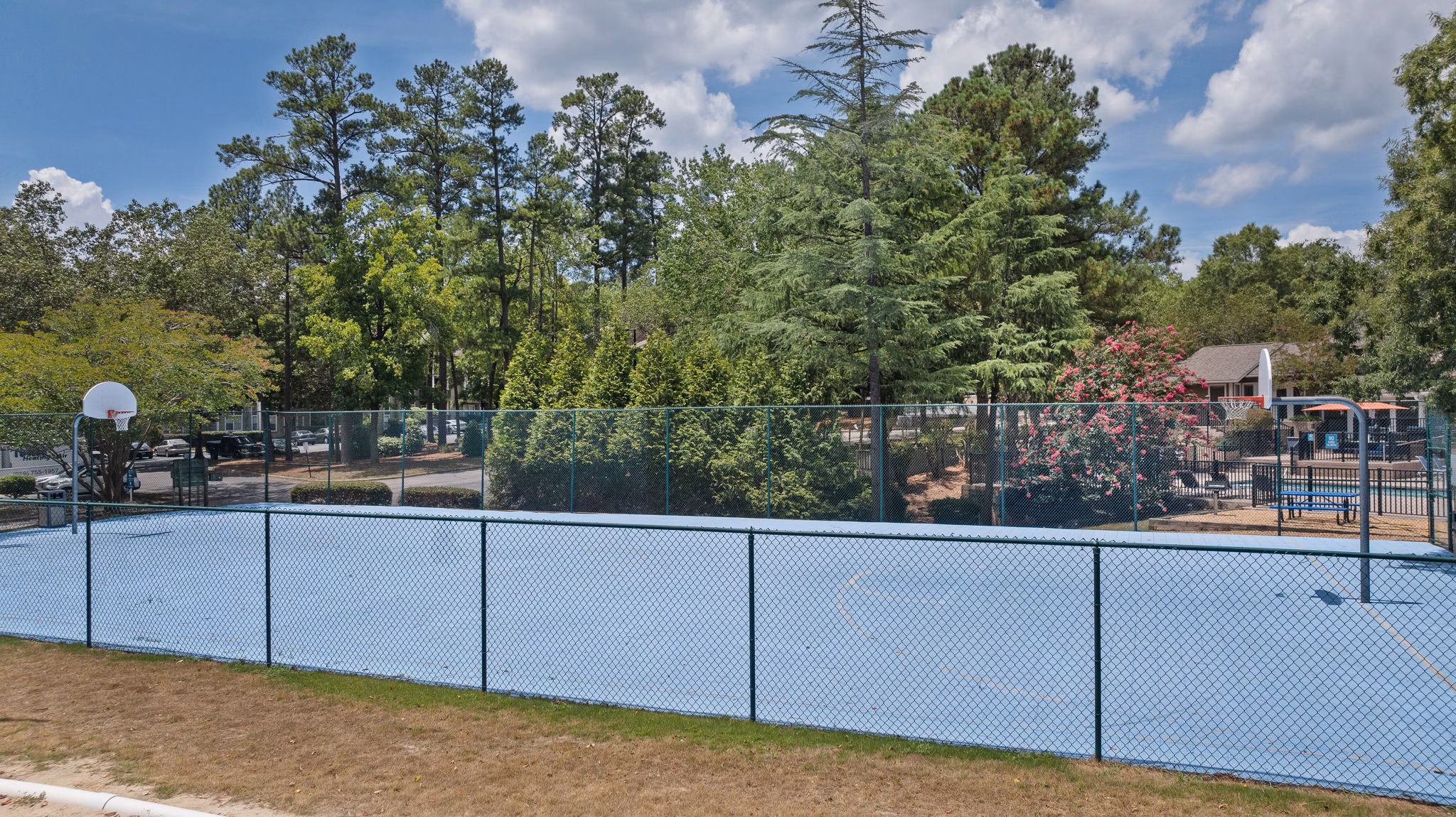 Sport court for basketball and tennis at Sunstone Apartments, featuring well-maintained facilities for active lifestyles