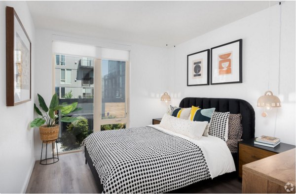 Arlo Apartments: Cozy bedroom with modern furnishings in luxury high-rise, perfect for urban living