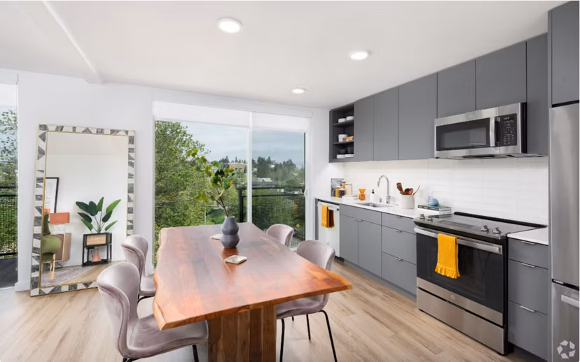 Modern kitchen featuring stainless steel appliances and quartz countertops in Arlo Apartments