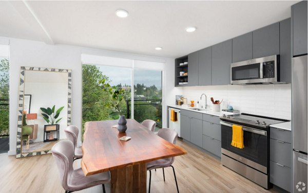 Modern kitchen featuring stainless steel appliances and quartz countertops in Arlo Apartments